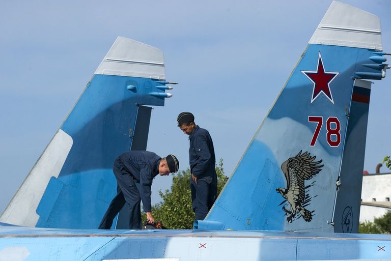 Военнослужащие подготавливают самолет СУ-33 к тренировочным полетам летчиков палубной авиации Военнослужащие подготавливают самолет СУ-33 к тренировочным полетам летчиков палубной авиации