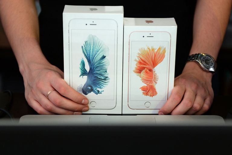 Продавец демонстрирует новые смартфоны Apple iPhone 6 и iPhone 6 plus Продавец демонстрирует новые смартфоны Apple iPhone 6 и iPhone 6 plus
