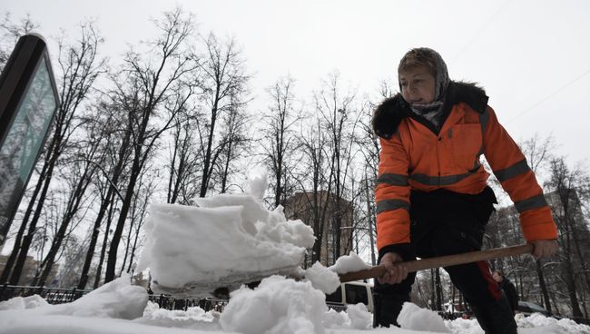 Работница ЖКХ убирает снег на одной из улиц Москвы. Архивное фото Работница ЖКХ убирает снег на одной из улиц Москвы. Архивное фото