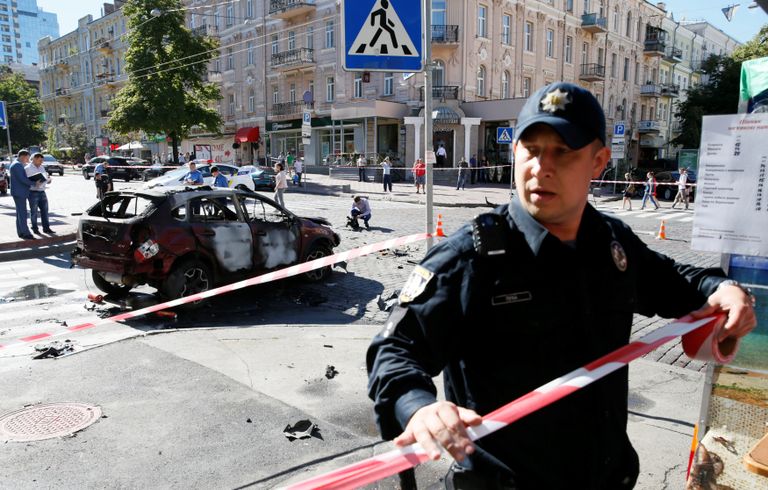 Сотрудник правоохранительных органов на месте взрыва автомобиля, в результате которого погиб журналист Павел Шеремет. Киев, Украина. 20 июля 2016 Сотрудник правоохранительных органов на месте взрыва автомобиля, в результате которого погиб журналист Павел Шеремет. Киев, Украина. 20 июля 2016