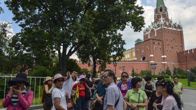 Туристы в Александровском саду в Москве. Архивное фото Туристы в Александровском саду в Москве. Архивное фото