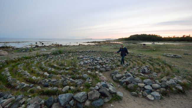 Туристы в древнем каменном лабиринте на берегу Белого моря Туристы в древнем каменном лабиринте на берегу Белого моря