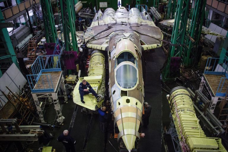 Сотрудники ПАО Компания Сухой Объединенной авиастроительной корпорации в одном из цехов по сборке самолета Т-50