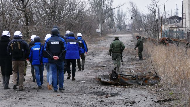 Сотрудники ОБСЕ во время посещения района обстрелов в Донбассе. Архивное фото
