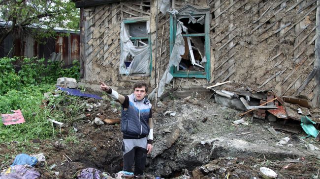 Подросток демонстрирует повреждения жилого дома, полученные в результате обстрела Куйбышевского района Донецка. Архивное фото Подросток демонстрирует повреждения жилого дома, полученные в результате обстрела Куйбышевского района Донецка. Архивное фото