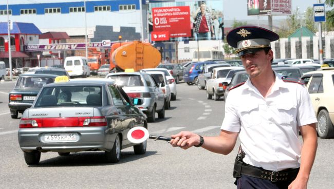 Сотрудник ГИБДД регулирует движение в городе Грозный Сотрудник ГИБДД регулирует движение в городе Грозный