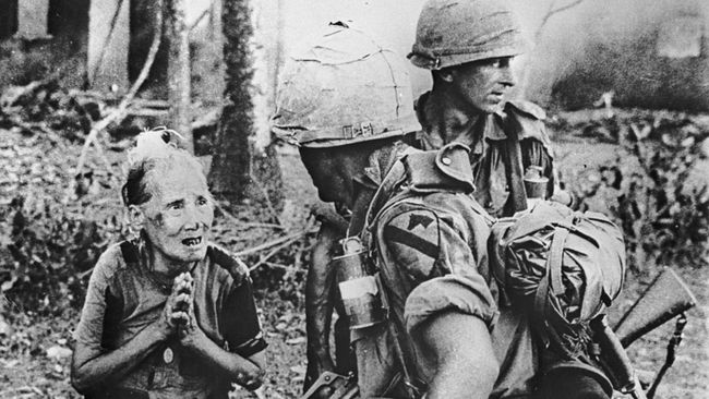 Американские военные и жительница одной из сожженных солдатами США вьетнамских деревень Американские военные и жительница одной из сожженных солдатами США вьетнамских деревень