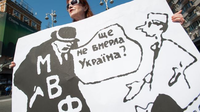 Женщина с плакатом про МВФ, Киев. Архивное фото Женщина с плакатом про МВФ, Киев. Архивное фото