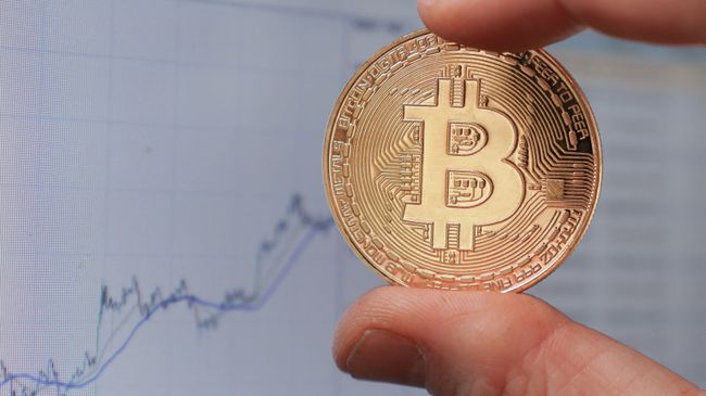 Монета с логотипом криптовалюты биткоин