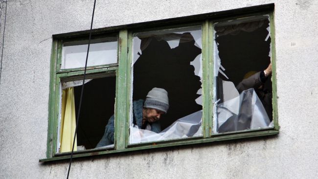 Женщина у окна жилого дома в центре города Ясиноватая, пострадавшего в результате обстрела. Архивное фото Женщина у окна жилого дома в центре города Ясиноватая, пострадавшего в результате обстрела. Архивное фото