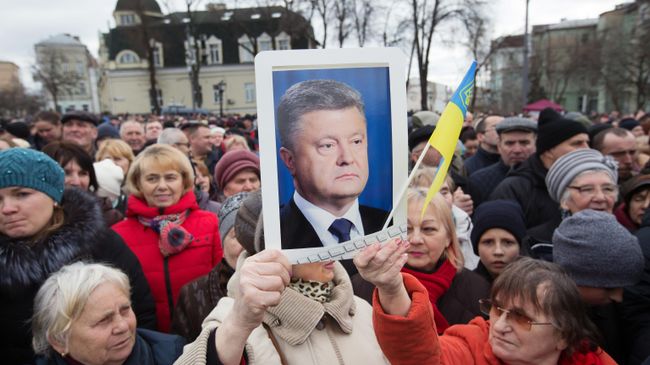Люди слушают предвыборную речь президента Украины Петра Порошенко на Михайловской площади в Киеве Люди слушают предвыборную речь президента Украины Петра Порошенко на Михайловской площади в Киеве
