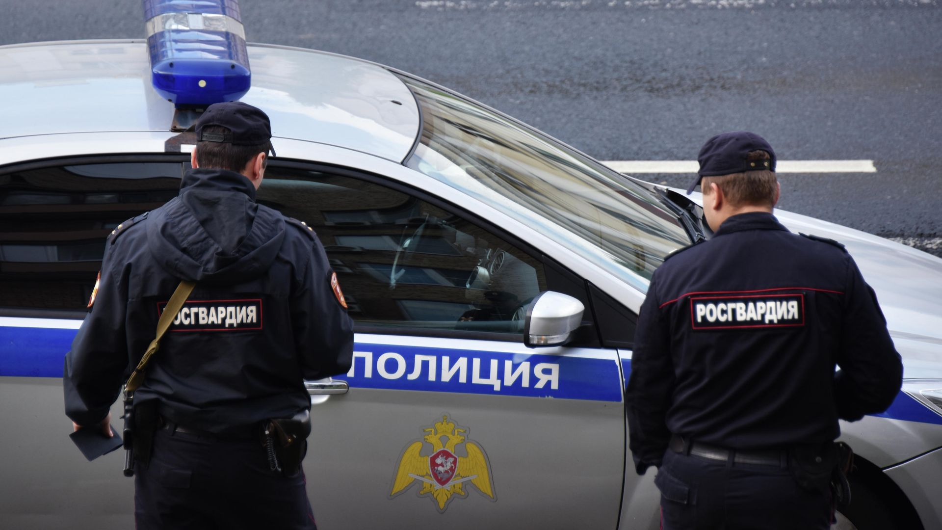 Сотрудники Росгвардии у полицейской машины Сотрудники Росгвардии у полицейской машины - РИА Новости, 1920, 04.07.2025