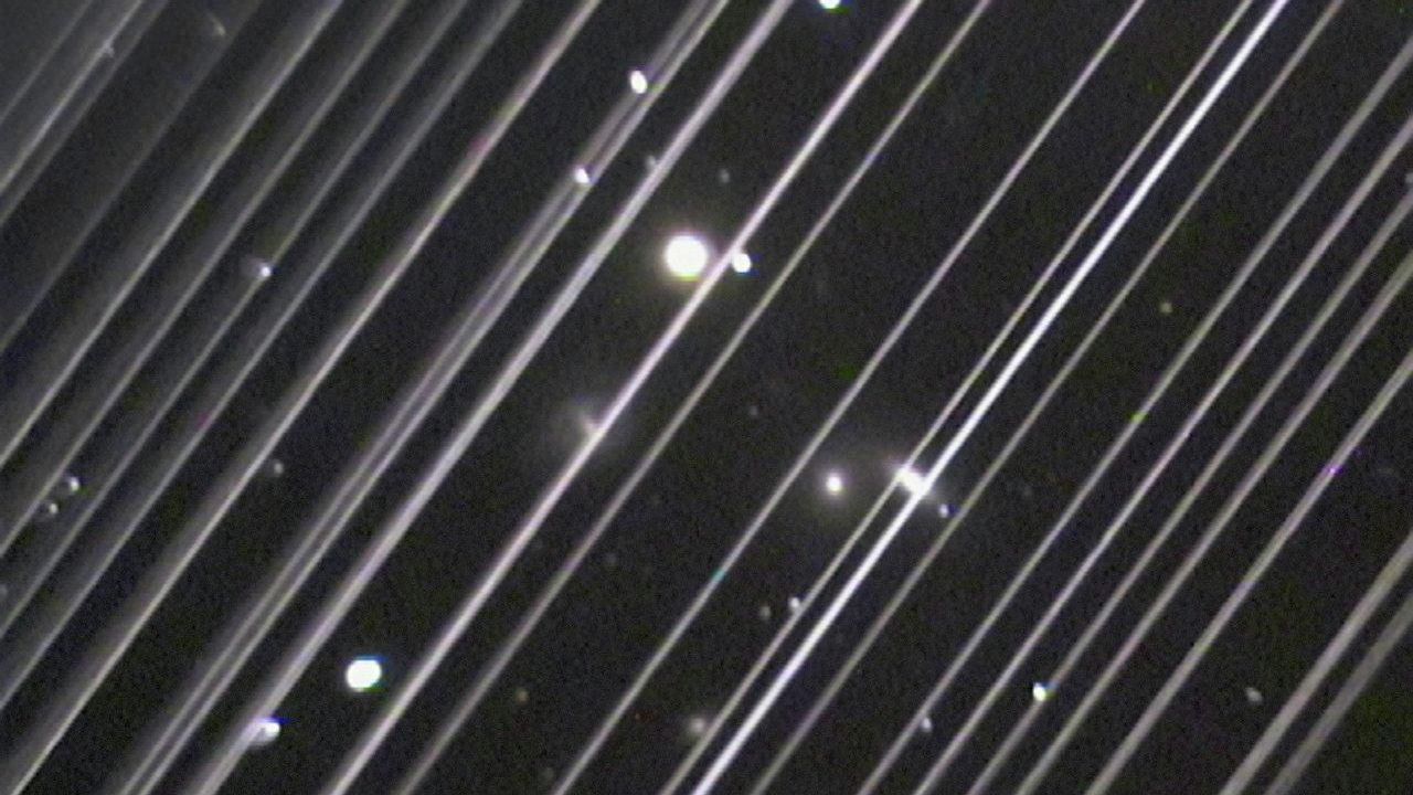 Фотография группы галактик NGC 5353/4 в созвездии Гончих Псов. Светлые линии на снимке — спутники системы Starlink Фотография группы галактик NGC 5353/4 в созвездии Гончих Псов. Светлые линии на снимке — спутники системы Starlink - РИА Новости, 1920, 07.12.2024