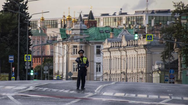 Сотрудник дорожно-патрульной службы у пешеходного перехода на улице Волхонке в Москве