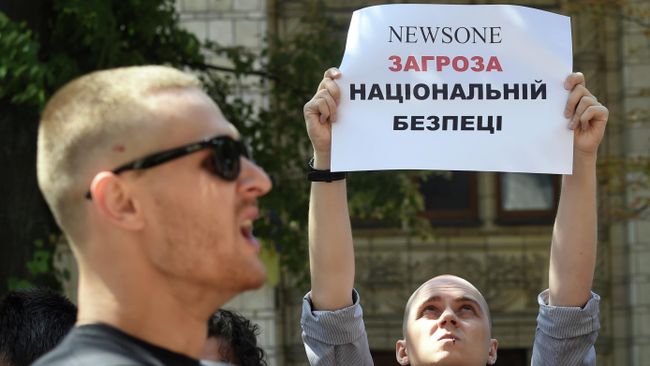 Участники акции протеста у офиса телеканала NewsOne против телемоста с российским каналом Россия 1