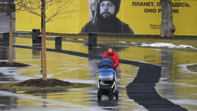 Девушка с коляской гуляет в Парке Горького в Москве Девушка с коляской гуляет в Парке Горького в Москве