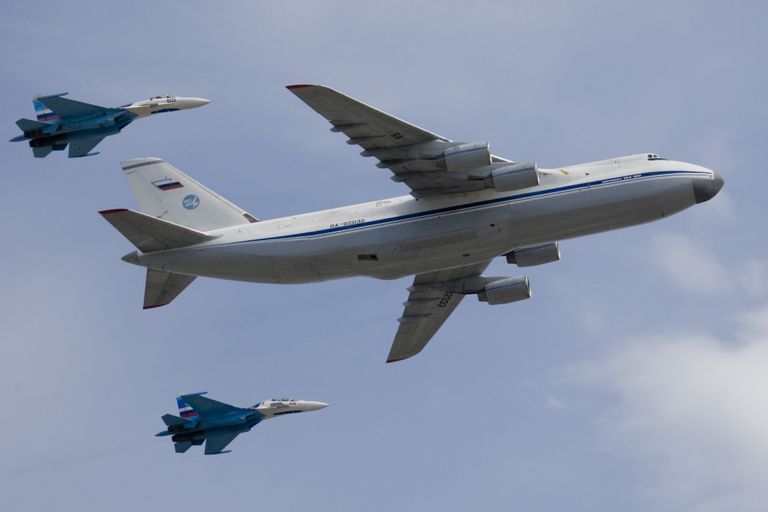 Стратегический военно-транспортный самолет Ан-124 Руслан в сопровождении двух истребителей Су-27 Стратегический военно-транспортный самолет Ан-124 Руслан в сопровождении двух истребителей Су-27