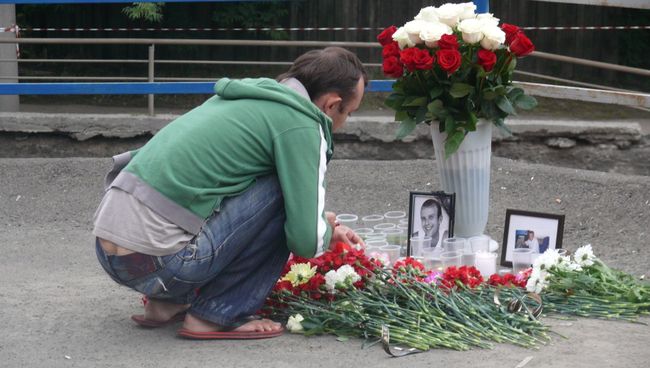 Люди несут цветы к месту гибели красноярцев под обрушившейся стеной Люди несут цветы к месту гибели красноярцев под обрушившейся стеной